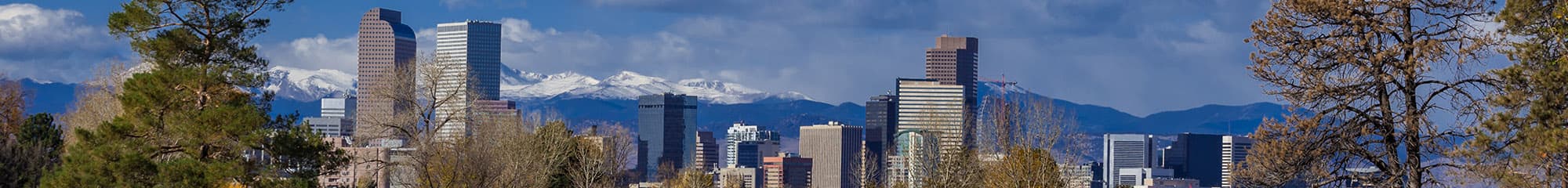 Downtown Denver skyline with the snow-capped Front Range behind it